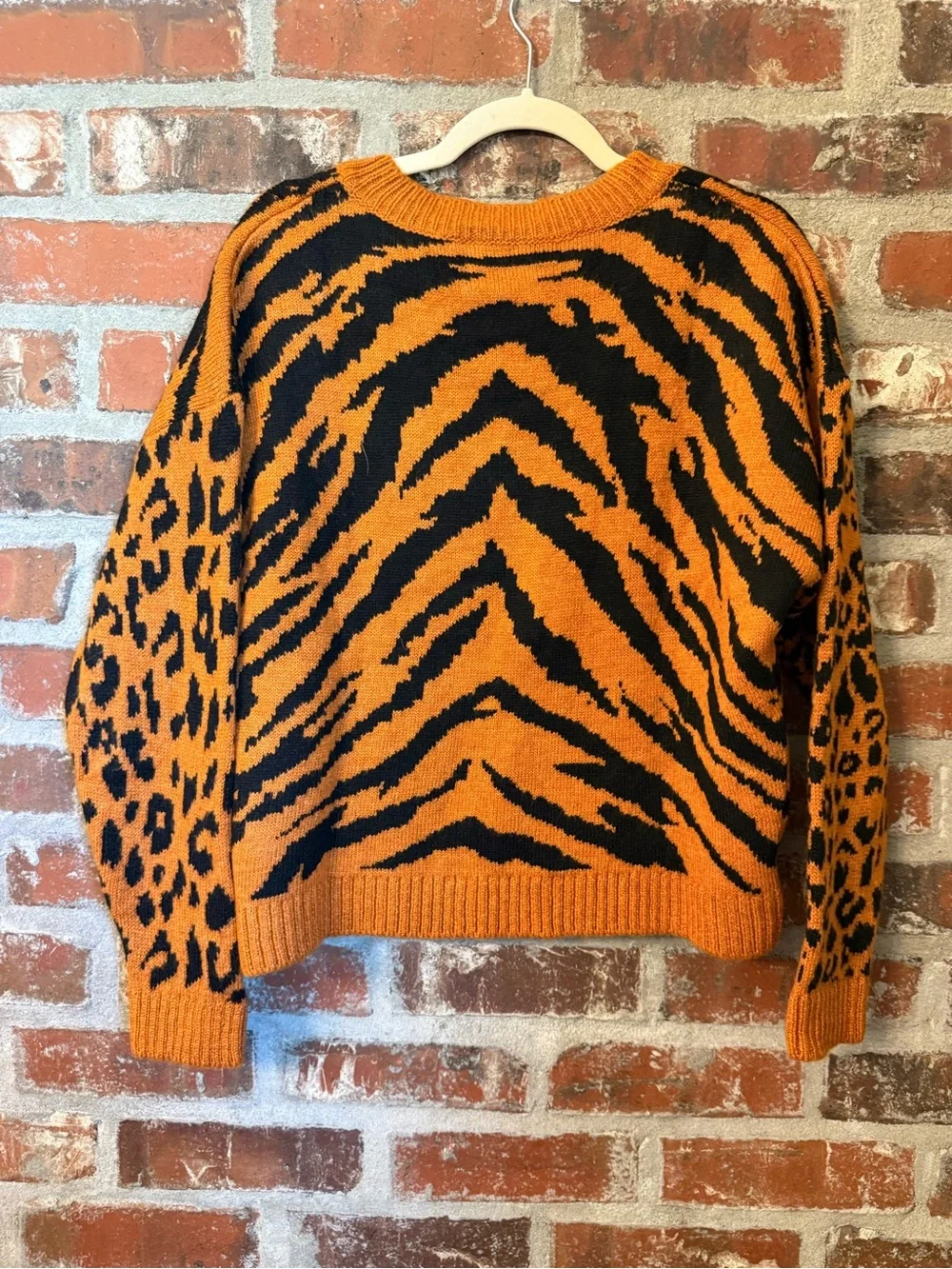 S46 - Francesca's Collections Orange and Black Animal-Print V-Neck Sweater